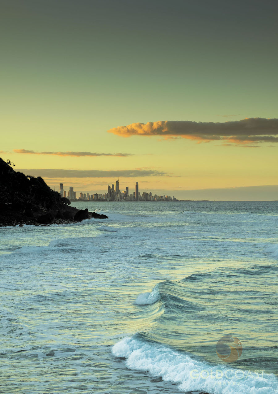 Waves crashing at Tallebudgera with Gold Coast City skyline behind Burleigh Heads